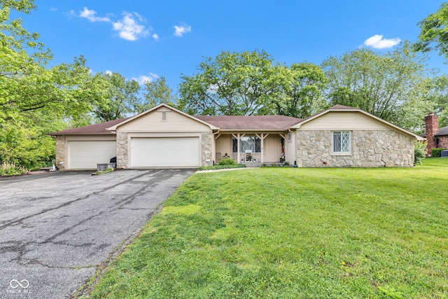 12121 E 21st St, Indianapolis, IN 46229 - single story home featuring stone siding, a garage, asphalt driveway, and a front lawn