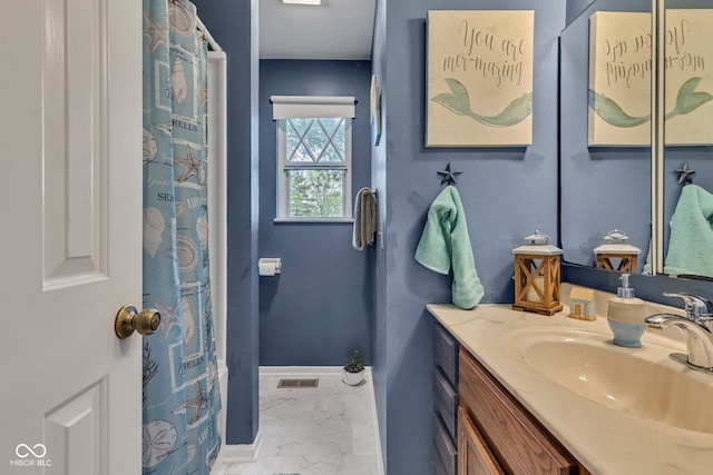 12121 E 21st St, Indianapolis, IN 46229 - full bath with marble look tiles, vanity, and baseboards
