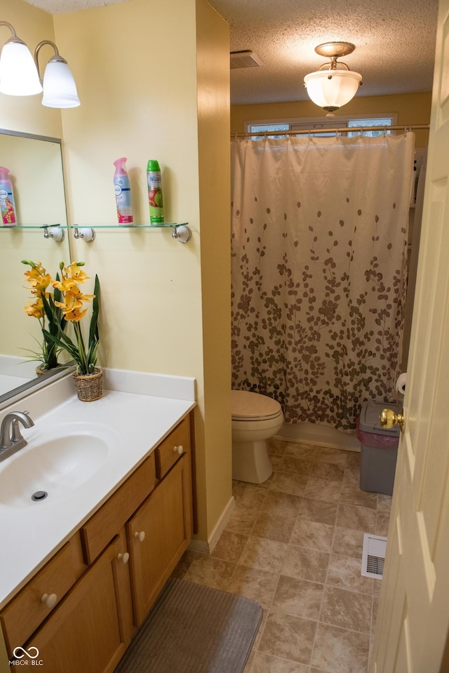 7402 Broadview Dr, Indianapolis, IN 46227 - full bathroom with vanity, toilet, and a textured ceiling