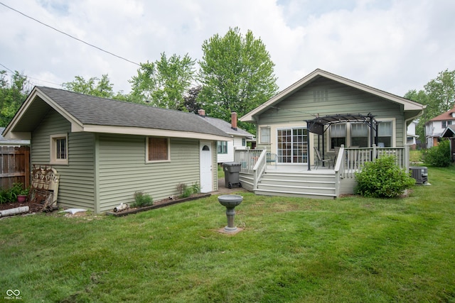 5133 E Michigan St, Indianapolis, IN 46219 - rear view of house with a wooden deck, a yard, central air condition unit, and an outbuilding