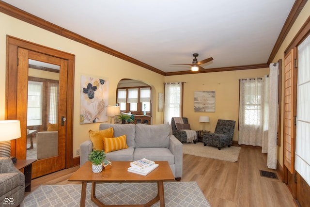 5133 E Michigan St, Indianapolis, IN 46219 - living area with a ceiling fan, light wood finished floors, crown molding, and arched walkways