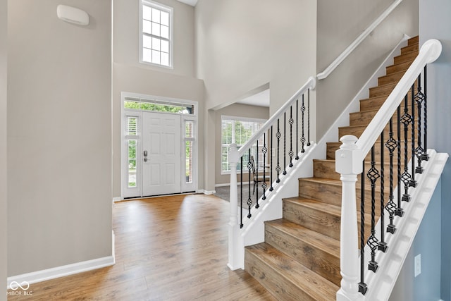 13766 Heatherfield Dr, Fishers, IN 46038 - foyer featuring stairs, wood finished floors, baseboards, and a high ceiling