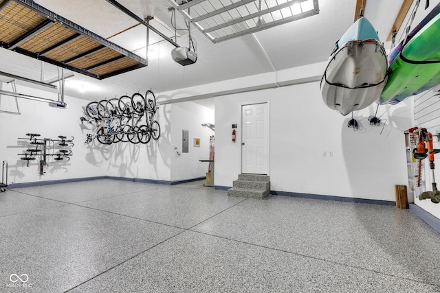 13766 Heatherfield Dr, Fishers, IN 46038 - garage featuring baseboards, a garage door opener, and electric panel