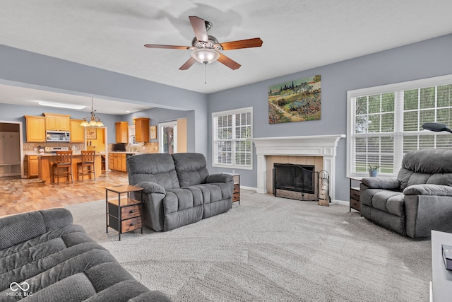 13766 Heatherfield Dr, Fishers, IN 46038 - living room with plenty of natural light, ceiling fan, a fireplace, and baseboards
