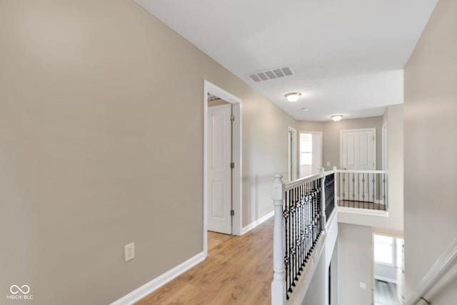 13766 Heatherfield Dr, Fishers, IN 46038 - hall with an upstairs landing, baseboards, plenty of natural light, and light wood-style floors