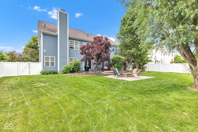 13766 Heatherfield Dr, Fishers, IN 46038 - back of property featuring a fire pit, a patio area, and a chimney