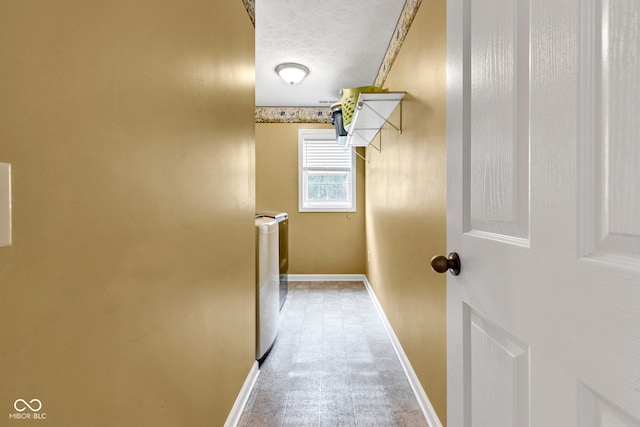 13766 Heatherfield Dr, Fishers, IN 46038 - hall with washer and clothes dryer, baseboards, and a textured ceiling