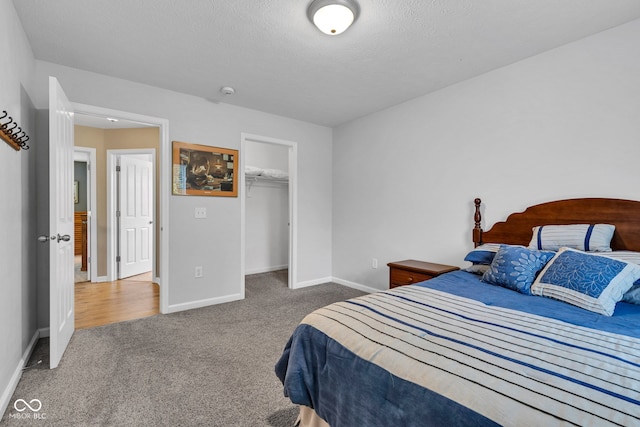 13766 Heatherfield Dr, Fishers, IN 46038 - carpeted bedroom with baseboards, a walk in closet, a closet, and a textured ceiling
