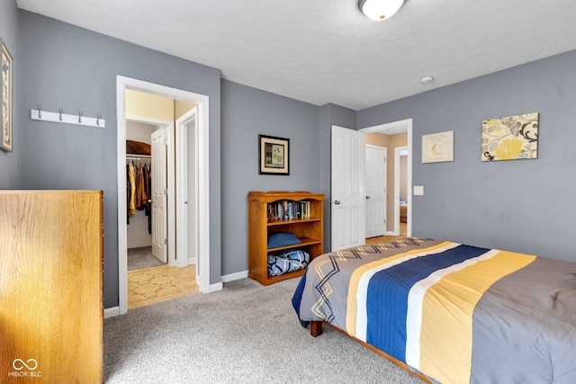 13766 Heatherfield Dr, Fishers, IN 46038 - carpeted bedroom with baseboards, a closet, and a walk in closet