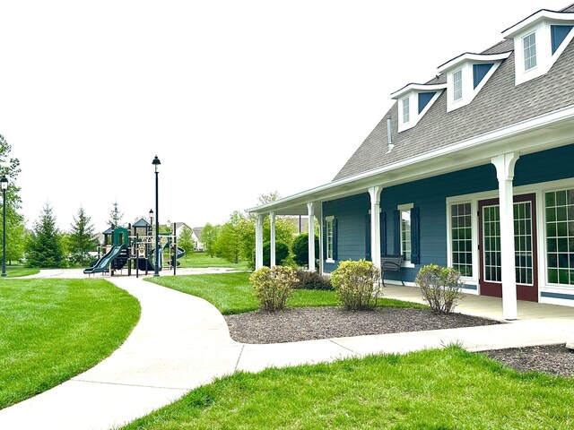 13766 Heatherfield Dr, Fishers, IN 46038 - view of side of property with a yard, a playground, roof with shingles, and a porch