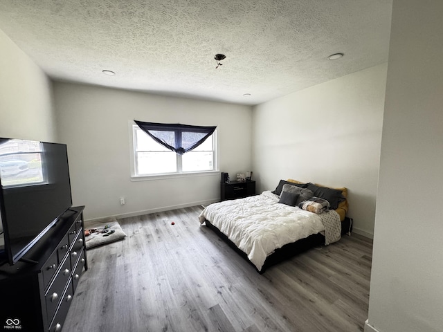 1206 Mcdougal St, Indianapolis, IN 46203 - bedroom featuring wood finished floors, a textured ceiling, and baseboards