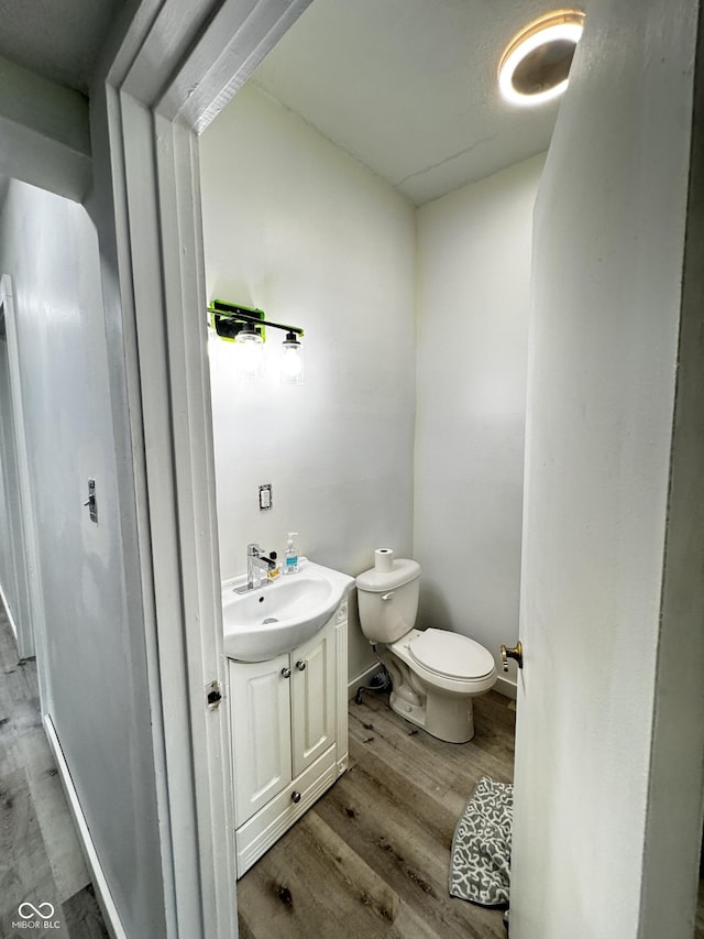1206 Mcdougal St, Indianapolis, IN 46203 - bathroom featuring wood finished floors, toilet, and vanity