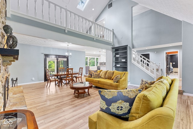 7630 Blain Way, Indianapolis, IN 46254 - living area featuring stairway, high vaulted ceiling, light wood-style floors, a chandelier, and baseboards
