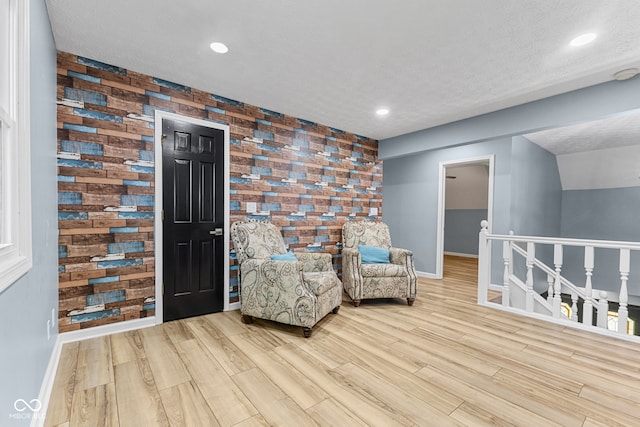 7630 Blain Way, Indianapolis, IN 46254 - sitting room with baseboards, an upstairs landing, wood finished floors, and a textured ceiling
