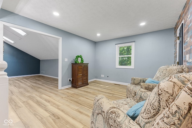 7630 Blain Way, Indianapolis, IN 46254 - living area with light wood-style floors, a skylight, recessed lighting, baseboards, and a textured ceiling