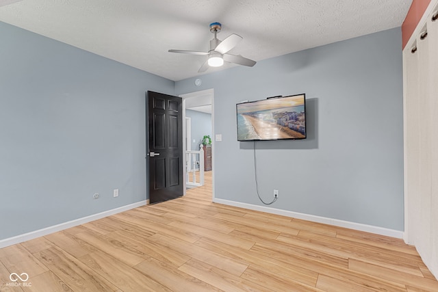 7630 Blain Way, Indianapolis, IN 46254 - unfurnished bedroom with light wood-style flooring, baseboards, ceiling fan, and a textured ceiling