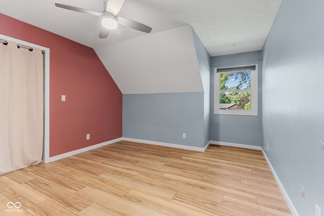 7630 Blain Way, Indianapolis, IN 46254 - bonus room featuring wood finished floors, ceiling fan, a textured ceiling, baseboards, and lofted ceiling