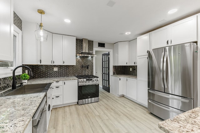 7630 Blain Way, Indianapolis, IN 46254 - kitchen with stainless steel appliances, wall chimney range hood, a sink, backsplash, and white cabinetry