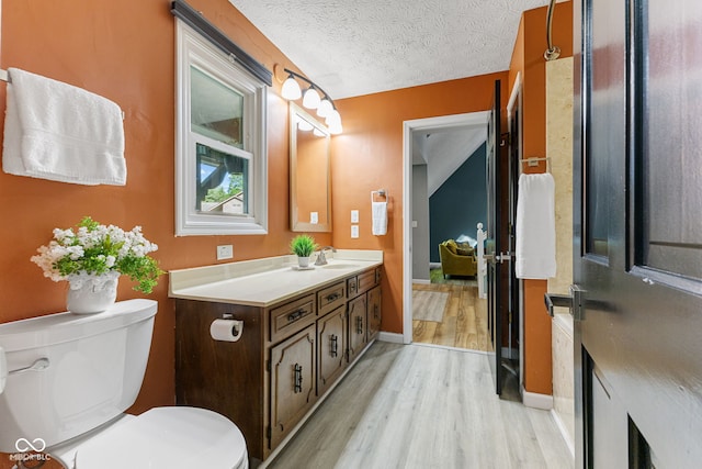 7630 Blain Way, Indianapolis, IN 46254 - bathroom with wood finished floors, vanity, toilet, a textured ceiling, and baseboards
