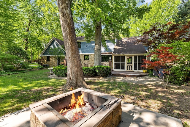 7630 Blain Way, Indianapolis, IN 46254 - back of property featuring a fire pit, a lawn, and a deck