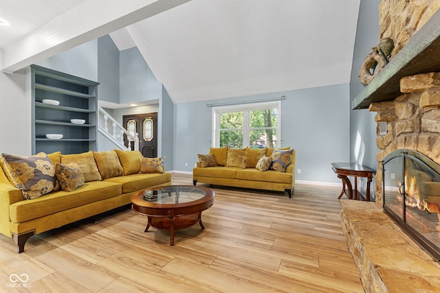 7630 Blain Way, Indianapolis, IN 46254 - living room with light wood finished floors, a fireplace, baseboards, and high vaulted ceiling