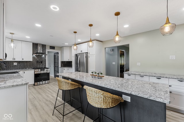 7630 Blain Way, Indianapolis, IN 46254 - kitchen with appliances with stainless steel finishes, wall chimney range hood, tasteful backsplash, light wood-type flooring, and white cabinets