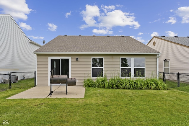 1313 Kenwood Dr, Greenwood, IN 46143 - back of house with a patio area, a shingled roof, and central air condition unit