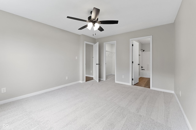 1313 Kenwood Dr, Greenwood, IN 46143 - unfurnished bedroom featuring carpet floors, a spacious closet, baseboards, a closet, and ensuite bath