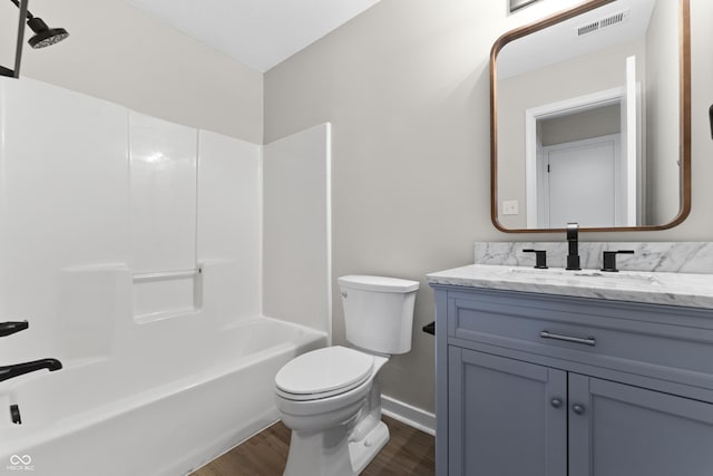 1313 Kenwood Dr, Greenwood, IN 46143 - full bath with wood finished floors, vanity, toilet, baseboards, and shower / washtub combination