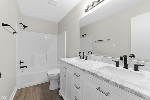 1313 Kenwood Dr, Greenwood, IN 46143 - full bathroom with toilet, double vanity, wood finished floors, and shower / bath combination