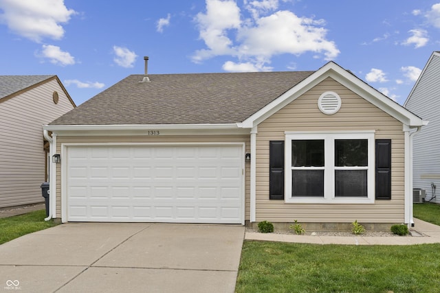 1313 Kenwood Dr, Greenwood, IN 46143 - view of front facade with driveway, a garage, a shingled roof, and cooling unit