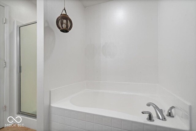 1905 Persimmon Grove Dr, Indianapolis, IN 46234 - bathroom featuring a bath and a shower with door