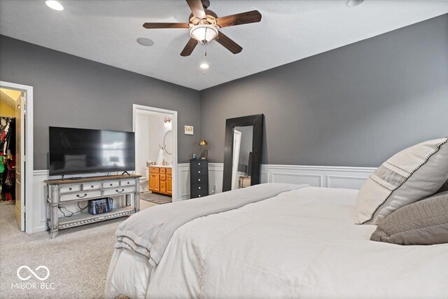 1905 Persimmon Grove Dr, Indianapolis, IN 46234 - bedroom featuring a walk in closet, light colored carpet, a closet, wainscoting, and ensuite bath