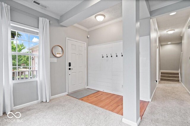 1905 Persimmon Grove Dr, Indianapolis, IN 46234 - entrance foyer featuring carpet flooring, crown molding, a textured ceiling, and baseboards