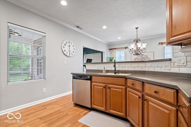 1905 Persimmon Grove Dr, Indianapolis, IN 46234 - kitchen with dishwasher, a sink, dark countertops, tasteful backsplash, and light wood-style flooring