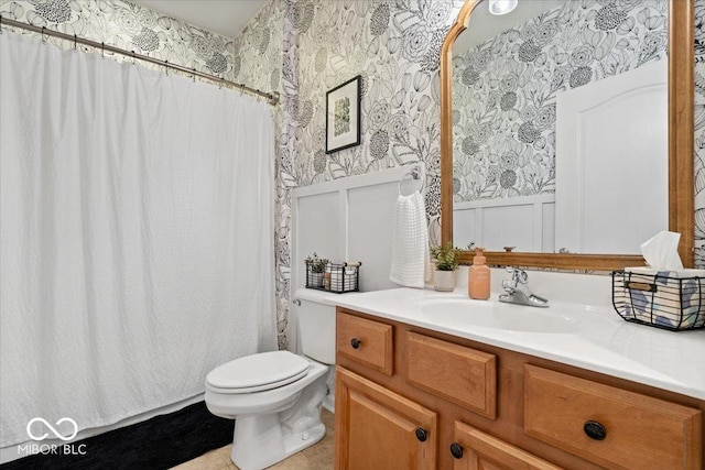 1905 Persimmon Grove Dr, Indianapolis, IN 46234 - bathroom with wallpapered walls, vanity, toilet, wainscoting, and tile patterned flooring
