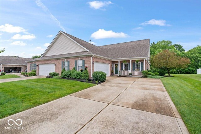 1905 Persimmon Grove Dr, Indianapolis, IN 46234 - view of front of home with a front lawn, a porch, an attached garage, brick siding, and concrete driveway
