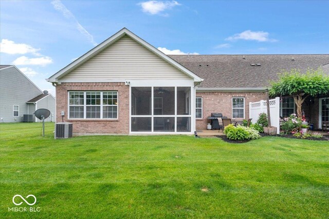 1905 Persimmon Grove Dr, Indianapolis, IN 46234 - back of property featuring brick siding, a yard, a sunroom, and central AC