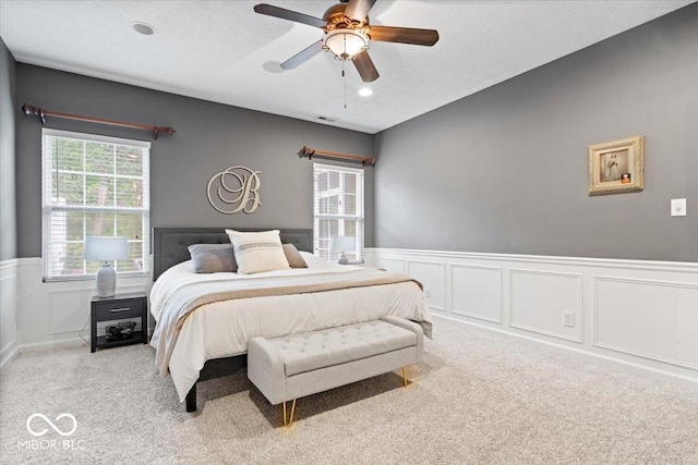 1905 Persimmon Grove Dr, Indianapolis, IN 46234 - carpeted bedroom featuring a wainscoted wall, a decorative wall, and ceiling fan