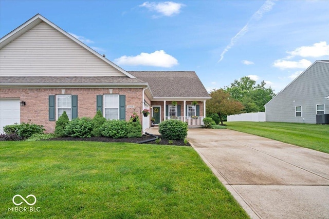 1905 Persimmon Grove Dr, Indianapolis, IN 46234 - view of front facade with covered porch, concrete driveway, brick siding, and a shingled roof