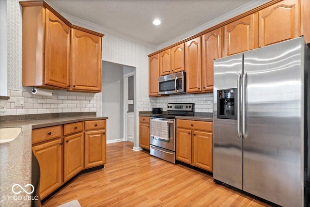 1905 Persimmon Grove Dr, Indianapolis, IN 46234 - kitchen with stainless steel appliances, ornamental molding, light wood-style flooring, decorative backsplash, and dark countertops