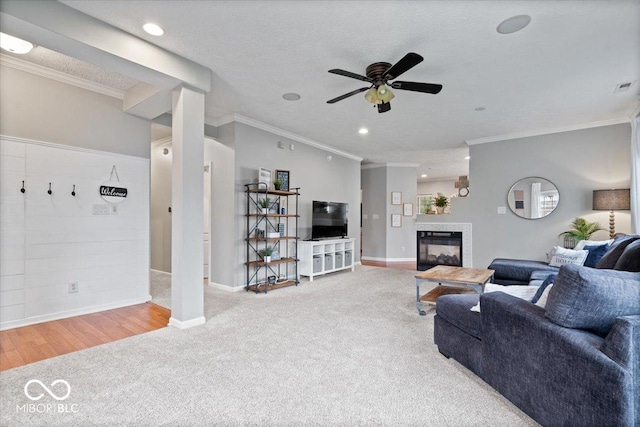 1905 Persimmon Grove Dr, Indianapolis, IN 46234 - carpeted living area featuring crown molding, a ceiling fan, a multi sided fireplace, baseboards, and recessed lighting