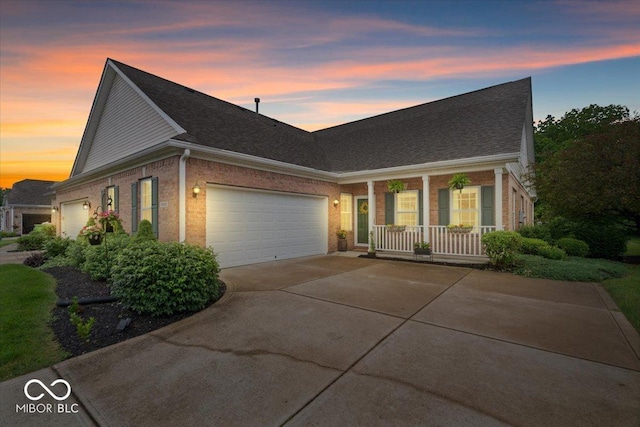 1905 Persimmon Grove Dr, Indianapolis, IN 46234 - traditional-style house featuring a porch, a garage, driveway, brick siding, and roof with shingles