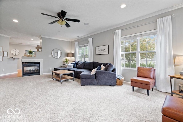 1905 Persimmon Grove Dr, Indianapolis, IN 46234 - carpeted living room featuring ornamental molding, baseboards, recessed lighting, a glass covered fireplace, and a ceiling fan