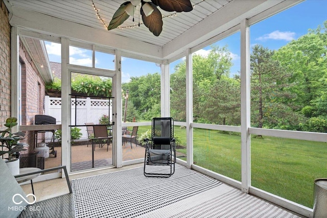 1905 Persimmon Grove Dr, Indianapolis, IN 46234 - unfurnished sunroom with ceiling fan and view of wooded area