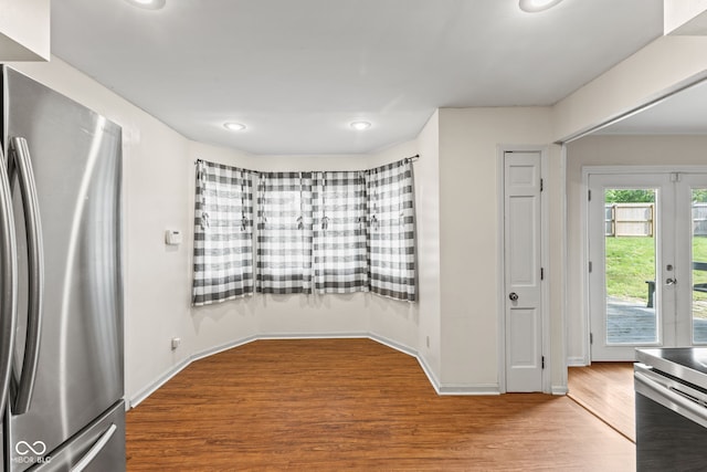 308 Hickory Hill Dr, Terre Haute, IN 47802 - kitchen with freestanding refrigerator, wood finished floors, french doors, recessed lighting, and baseboards