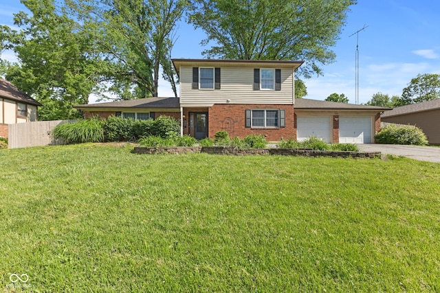 308 Hickory Hill Dr, Terre Haute, IN 47802 - traditional-style home featuring a garage, brick siding, and driveway
