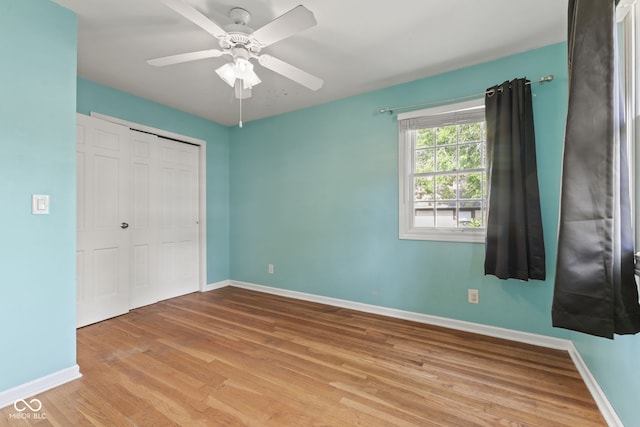 308 Hickory Hill Dr, Terre Haute, IN 47802 - unfurnished bedroom with baseboards, light wood-type flooring, a closet, and a ceiling fan