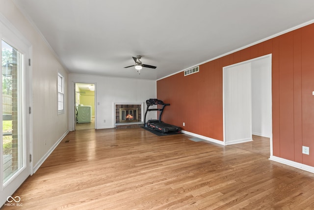 308 Hickory Hill Dr, Terre Haute, IN 47802 - unfurnished living room with a fireplace, light wood-style flooring, crown molding, a ceiling fan, and baseboards