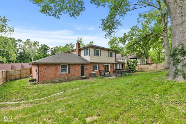 308 Hickory Hill Dr, Terre Haute, IN 47802 - back of property with brick siding, a chimney, a shingled roof, and central AC unit